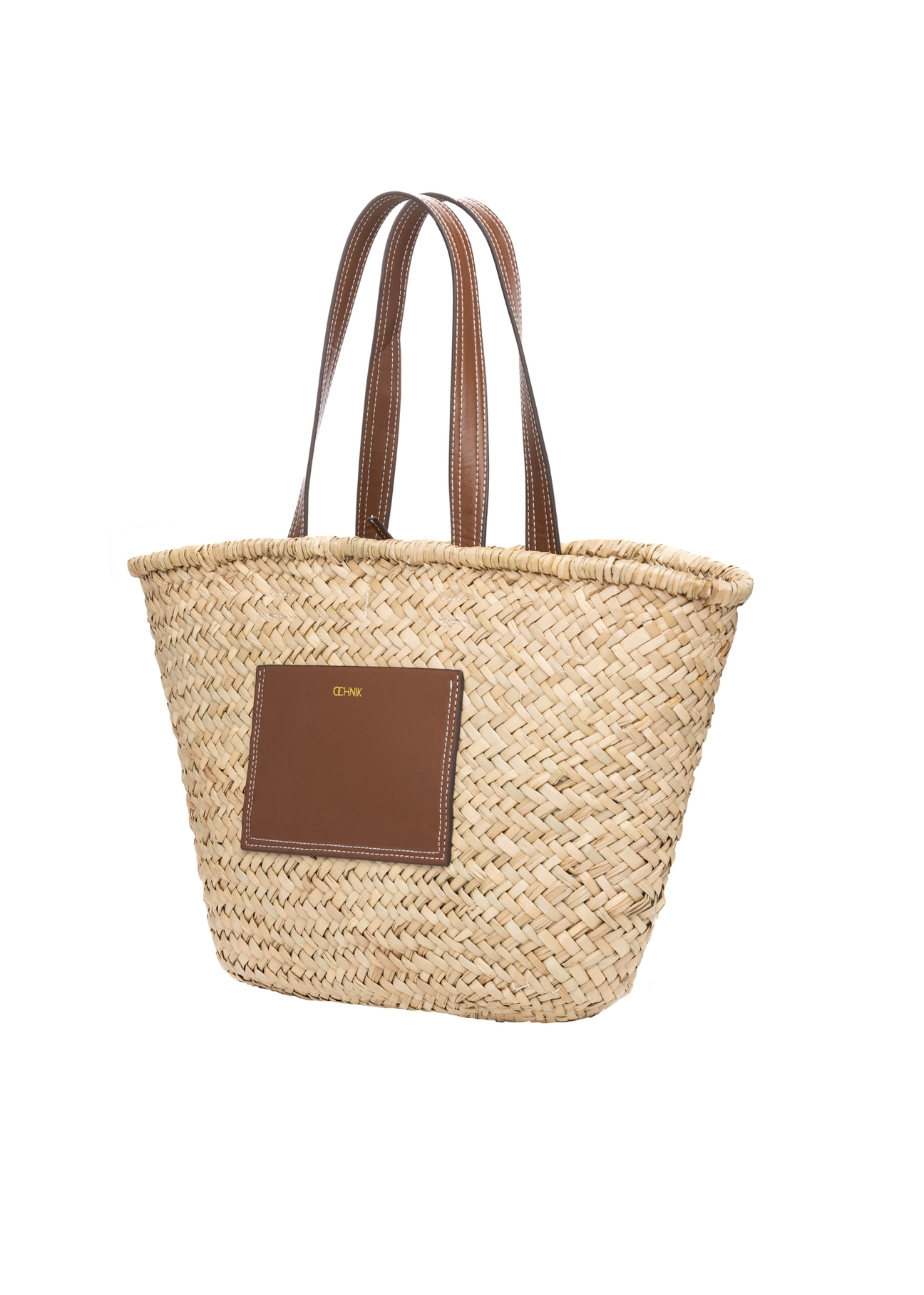 Słomkowa torebka damska typu shopper TOREC-1219-1E(W26), widok produktu skosem na białym tle.