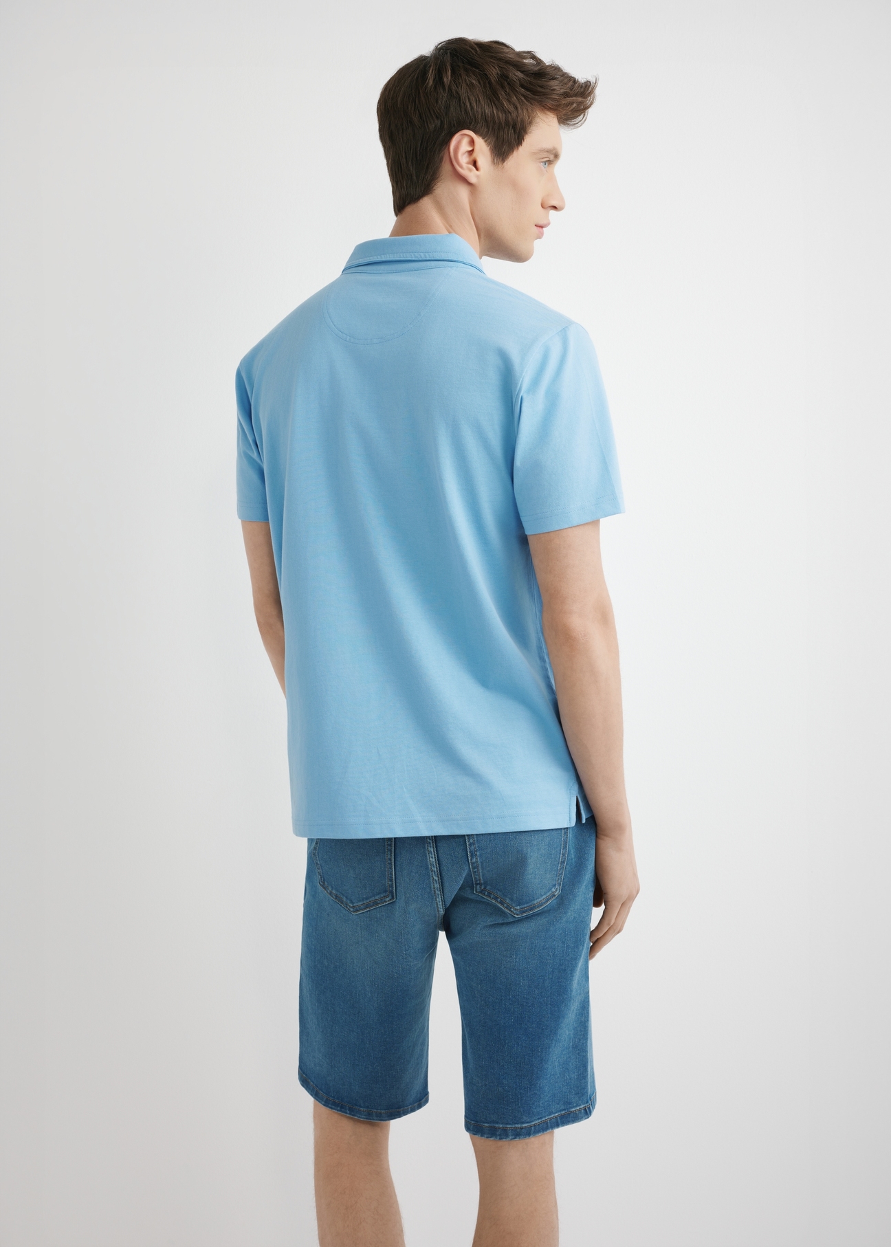 Niebieska męska koszulka polo POLMT-0088-7B(W26), widok produktu z tyłu na modelu. Widoczna połowa sylwetki.